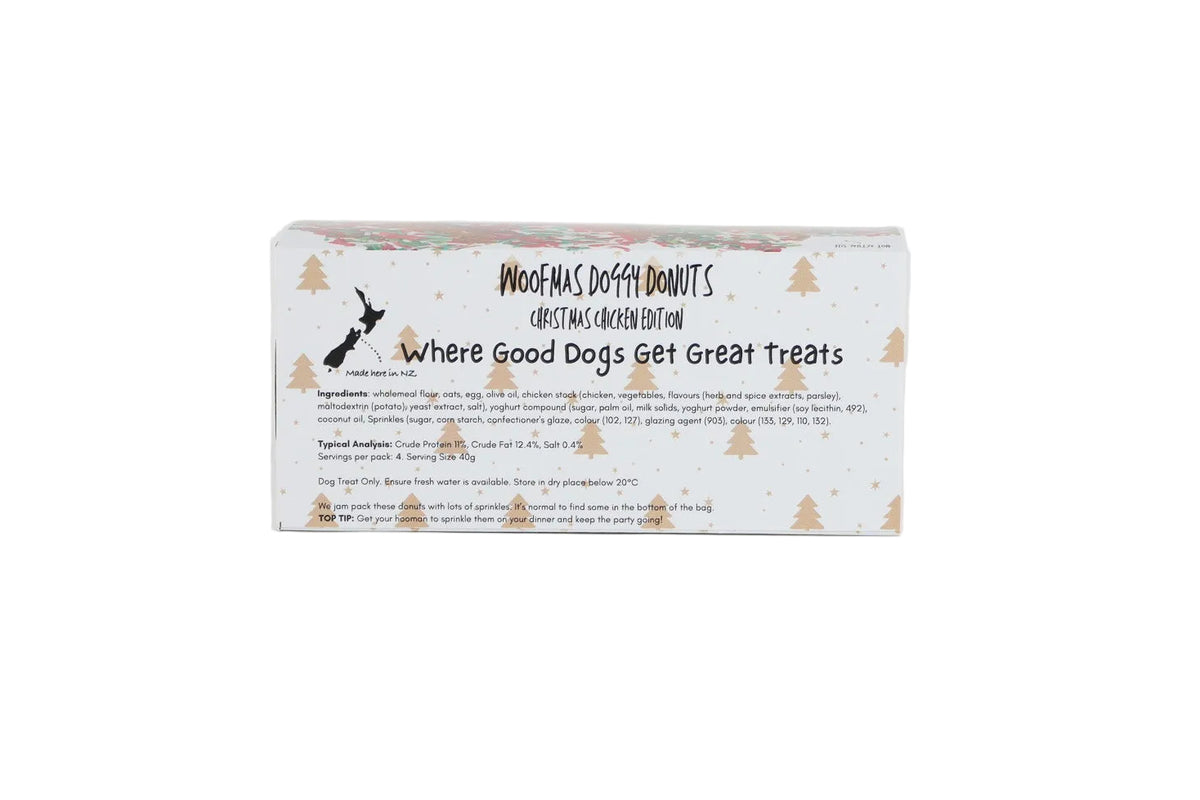 A rectangular box of Woofmas Doggy Donut treats, featuring a white background with black text and small gold pine tree illustrations, set against a plain white studio background.