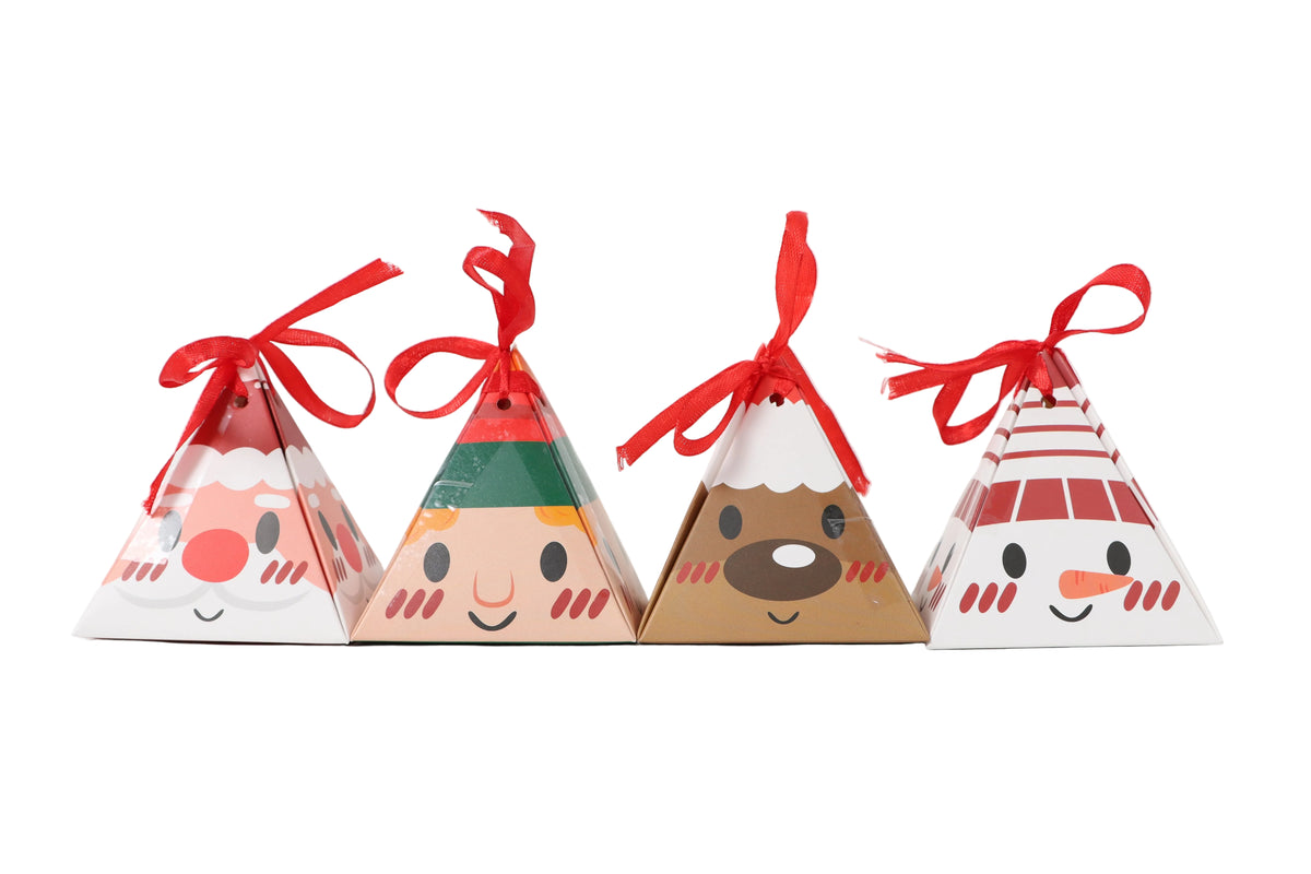 Four small triangular paper gift boxes with red ribbon tops, each printed with a different holiday face design, arranged on a white background.