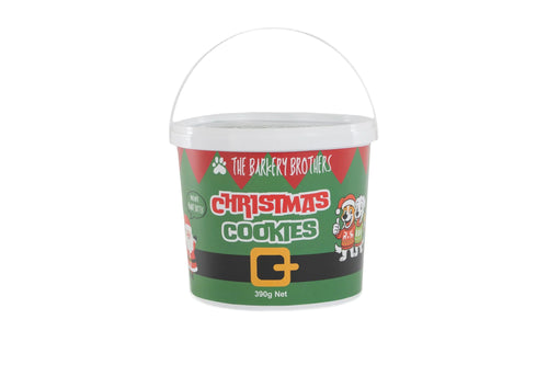 A white plastic bucket of 'The Barkery Brothers' Christmas Cookies, featuring a festive green and red label with a black belt graphic and a white handle, set against a plain white background.