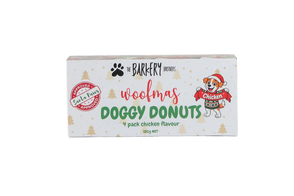 A rectangular box of 'woofmas DOGGY DONUTS' dog treats by 'The Barkery Brothers' on a plain white background.